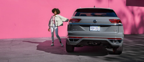 Person Leaning Against a parked 2023 Volkswagen Atlas Cross