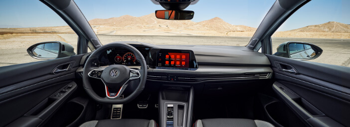 2023 Volkswagen Golf GTI with black leather interior parked in deserted field
