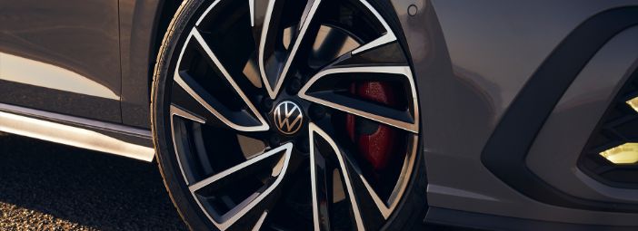 Dark grey 2023 Volkswagen Golf GTI front passenger wheel with aluminium rim