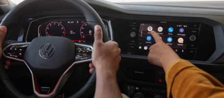 Person pressing maps icon on infotainment screen in 2023 Volkswagen Jetta GLI