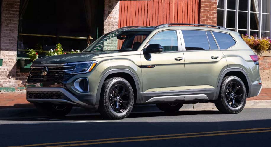 Avocado Green Pearl 2025 Volkswagen Atlas parked outside a building