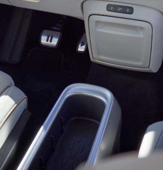 A view of the front passenger seat and center console in the Volkswagen ID. Buzz 2025, highlighting the spacious storage compartment.
