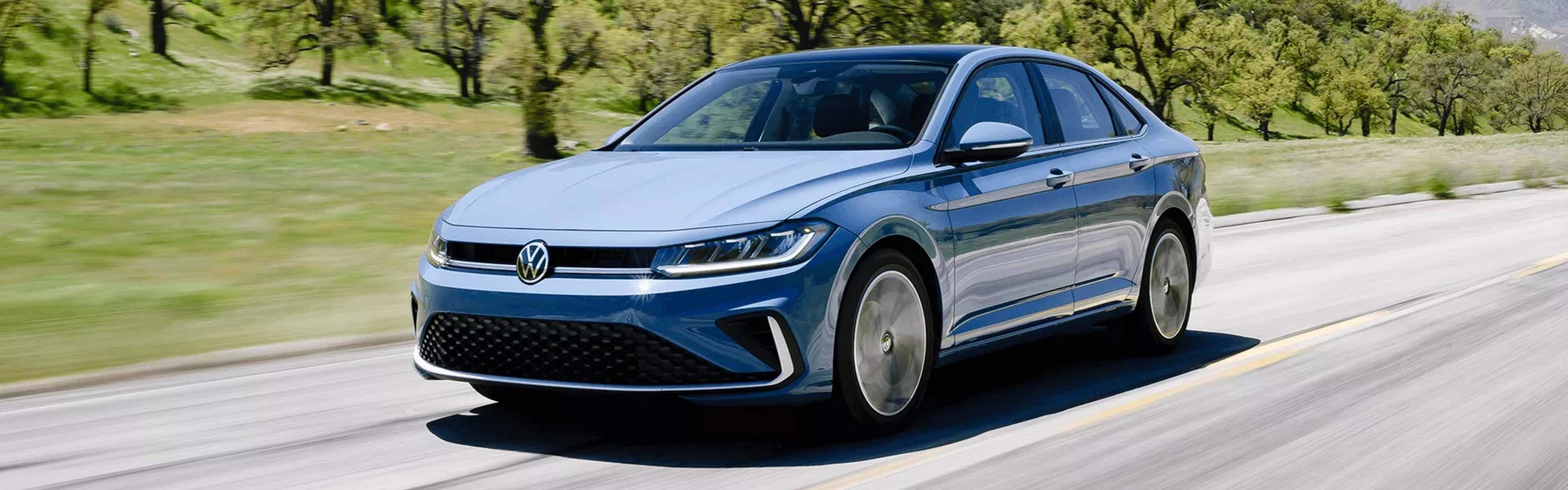 2025 Volkswagen Jetta driving down the road
