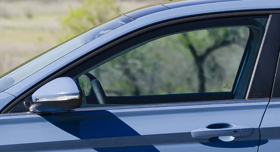 Close-up of the VW Jetta's driver-side door, highlighting the KESSY keyless access feature with a push-start button.