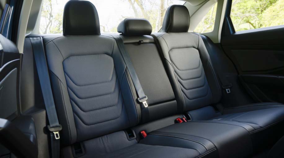 Rear interior of the 2026 Jetta featuring leather seats with visible stitching and ample legroom.