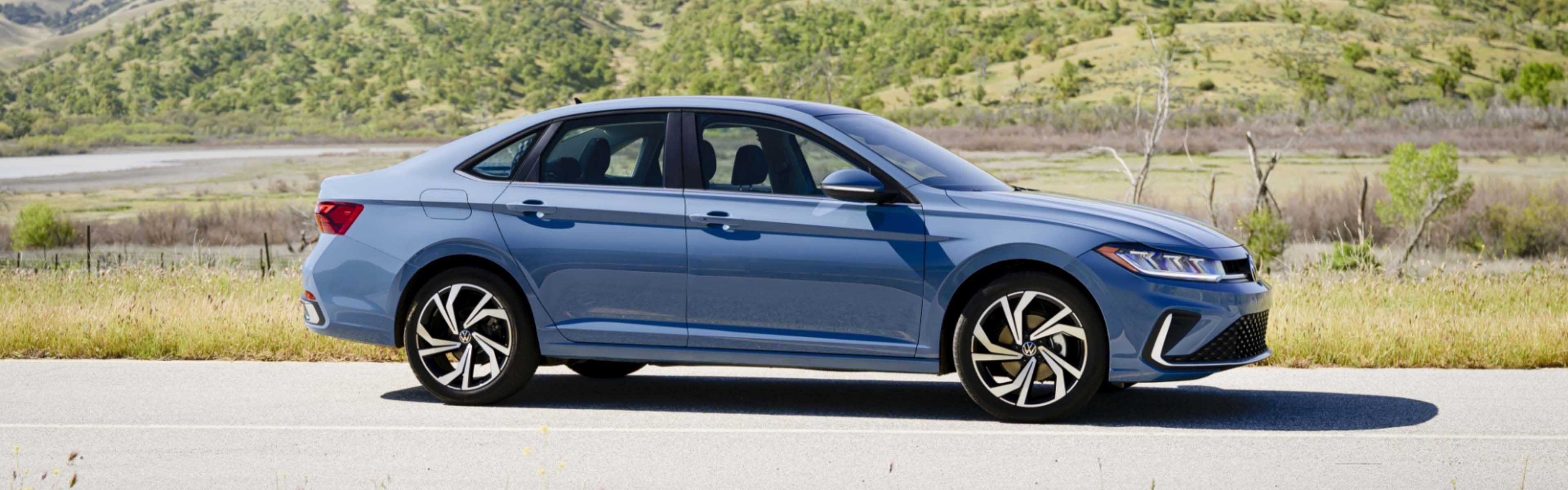 2026 Jetta parked near a grass hill