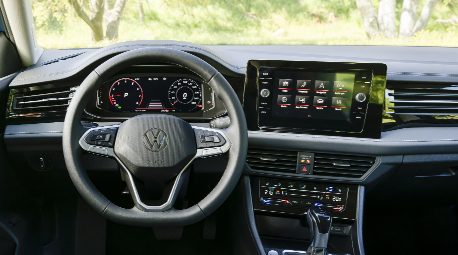 Interior view of the 2026 Volkswagen Jetta from the driver's seat, showing the steering wheel, digital cockpit, and infotainment screen