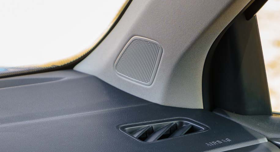 Close-up of speaker grille and rear tray inside the 2026 Volkswagen Taos, representing the new VW premium audio system.