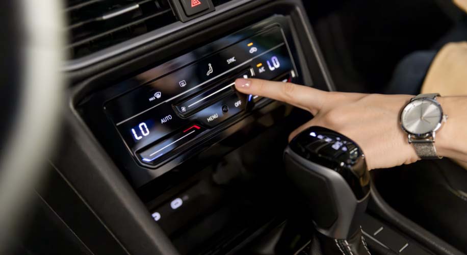Close-up of the 2026 Volkswagen Taos Climatronic touchscreen climate control panel.