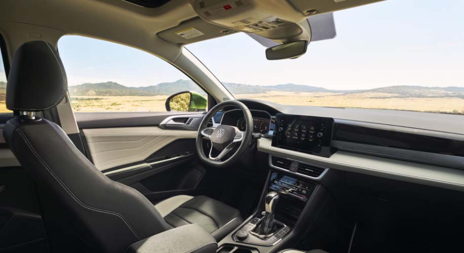 Interior view of the 2026 Volkswagen Taos showing front seats with ventilated and heated features and panoramic sunroof.