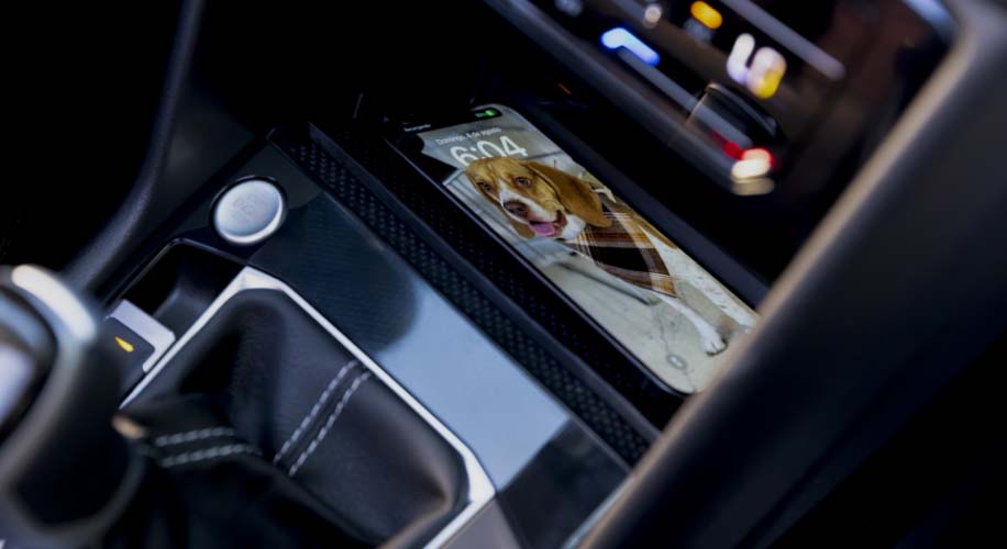 Wireless charging pad inside the 2026 Volkswagen Taos with a phone placed on it.