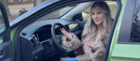 Woman sitting in the driver seat of a Volkswagen Taos