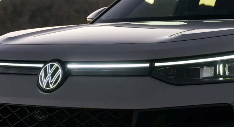 The sleek design of the 2025 volkswagen tiguan%27s front end showcasing its headlights and illuminated logo