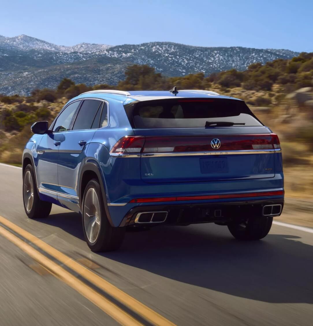 Blue VW Atlas Cross Sport driving on the road