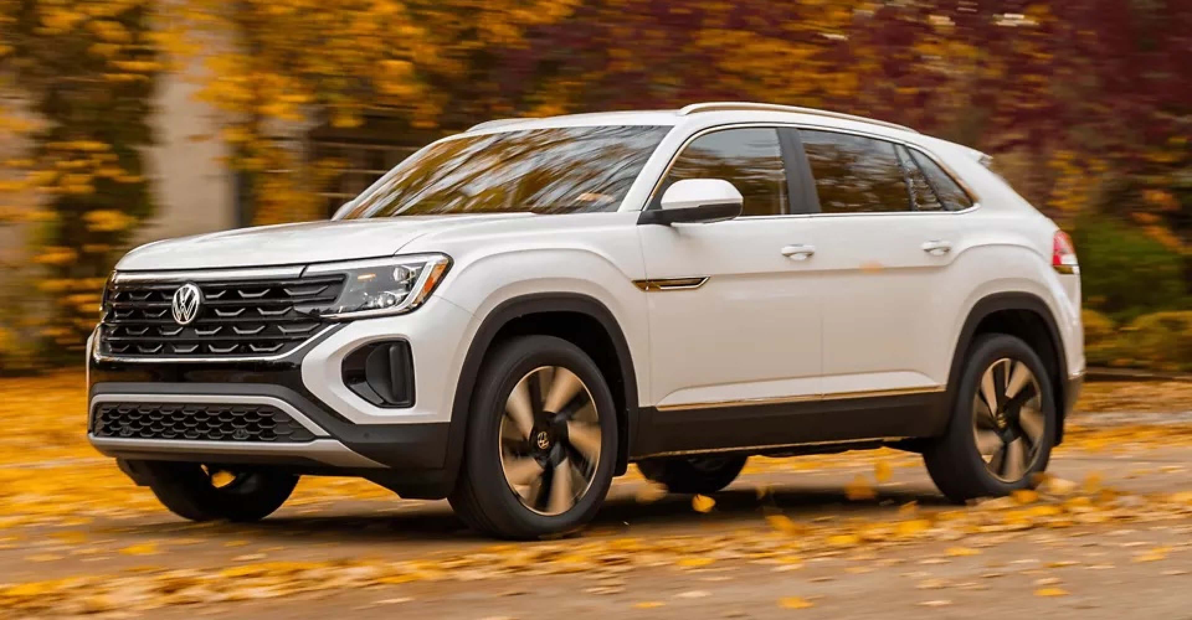 White Atlas Cross Sport driving through leaves