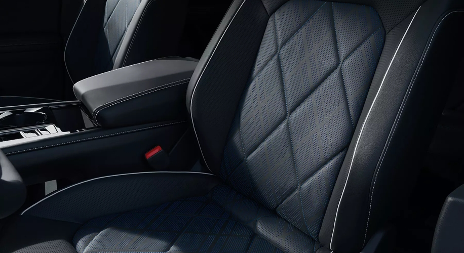 A close-up view of a black leather Atlas Cross Sport seat with massage function.