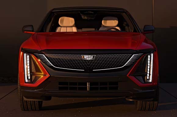 front_view_of_red_cadillac_lyriq_with_led_headlights_at_sunset