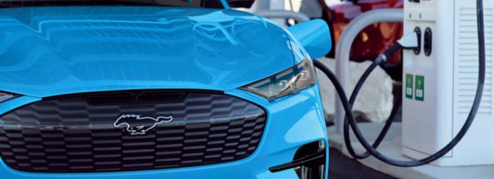 Mach-E plugged in and charging at a public charging station. Plug in However You Choose Charge at Home