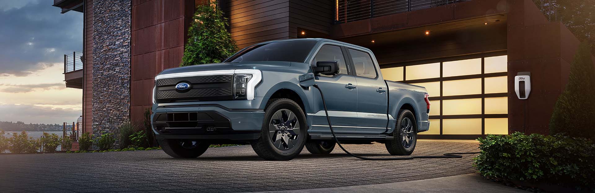 F150 Lightning plugged in and charging outside of a home.
