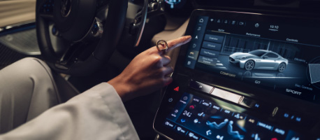 person interacting with touchscreen system inside the maserati granturismo
